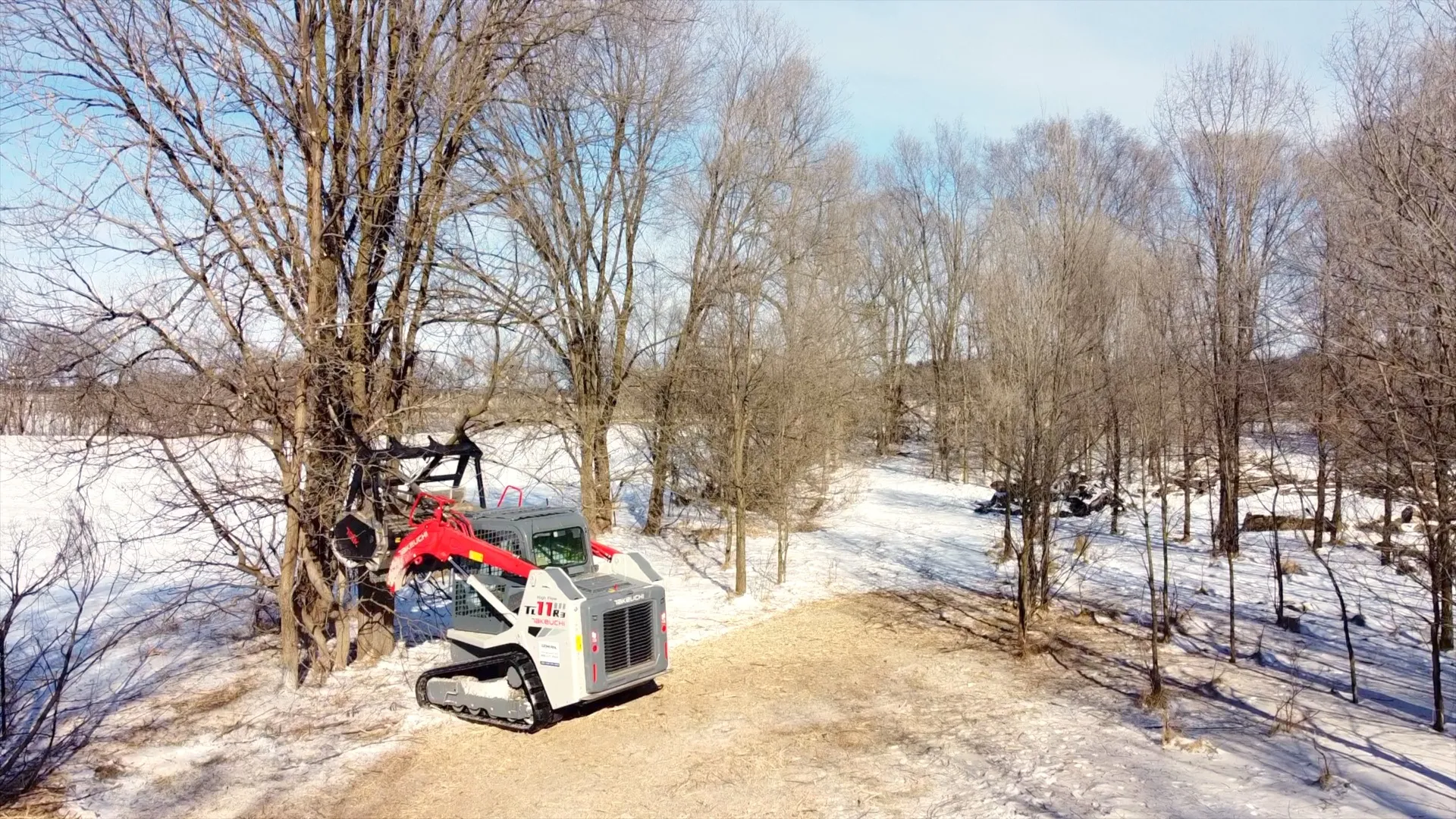 Aerial view of Takeuchi forestry mulcher clearing trees on a Wisconsin property